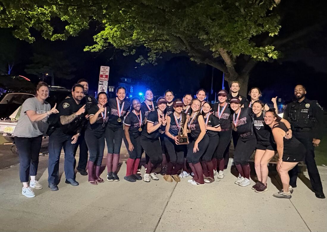Team photo with local police officers celebrating the team's title