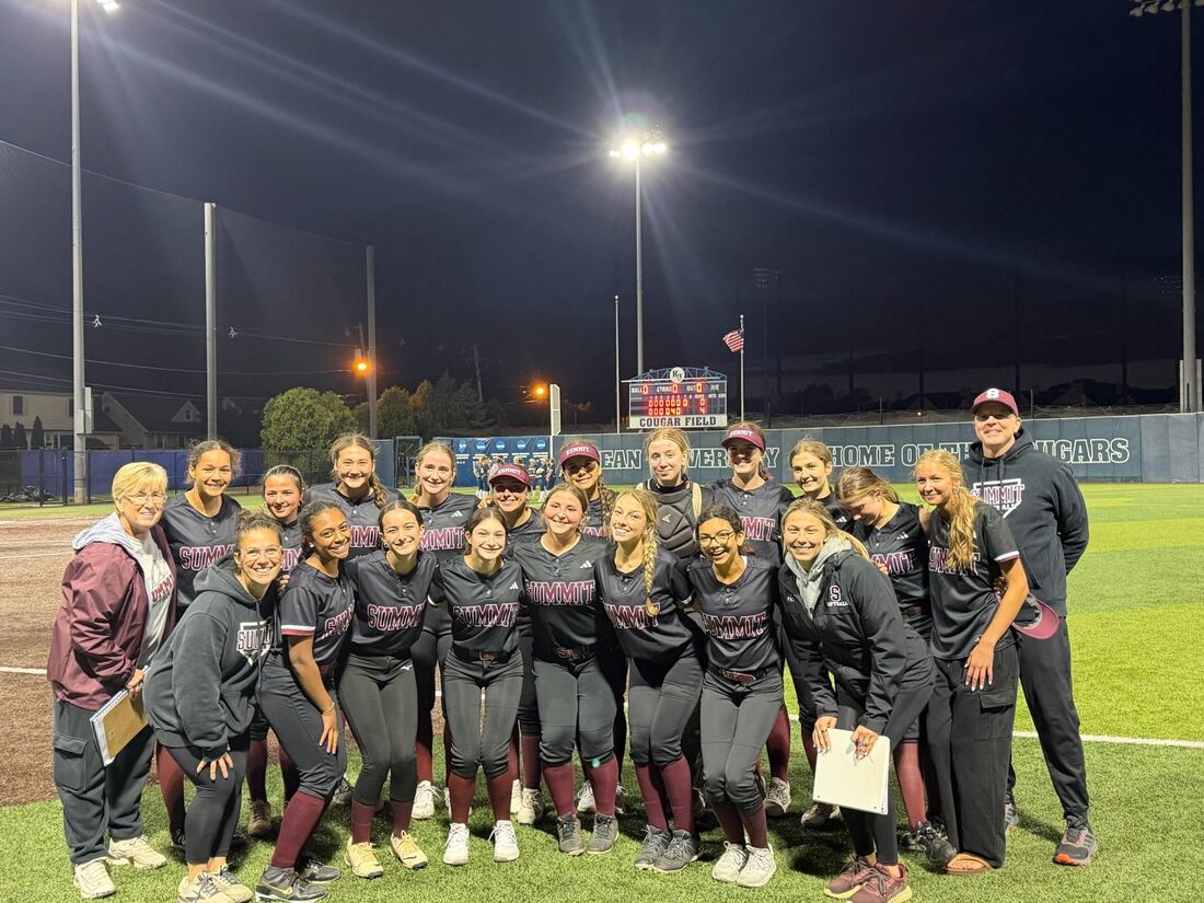 Team photo on the field at Kean University at night