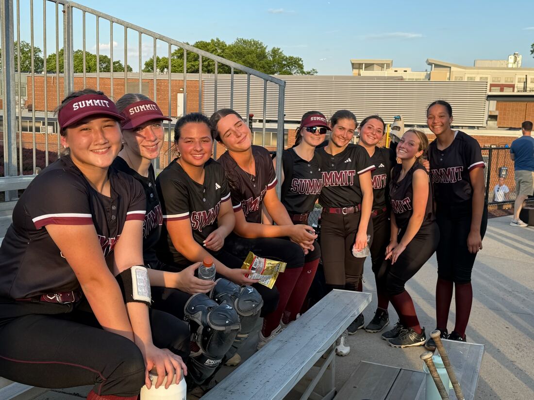 Players relaxing on the bleachers with snacks between games